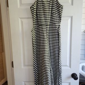 Cropped, sleeveless, high neck jumpsuit with pockets and a belt